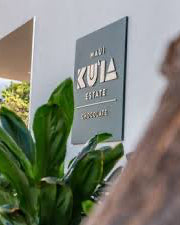 Kula Estate sign with greenery in the foreground