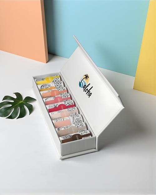 Set of nine mini lip butters in a white box with 'aloha' branding inside the box lid on a light background.