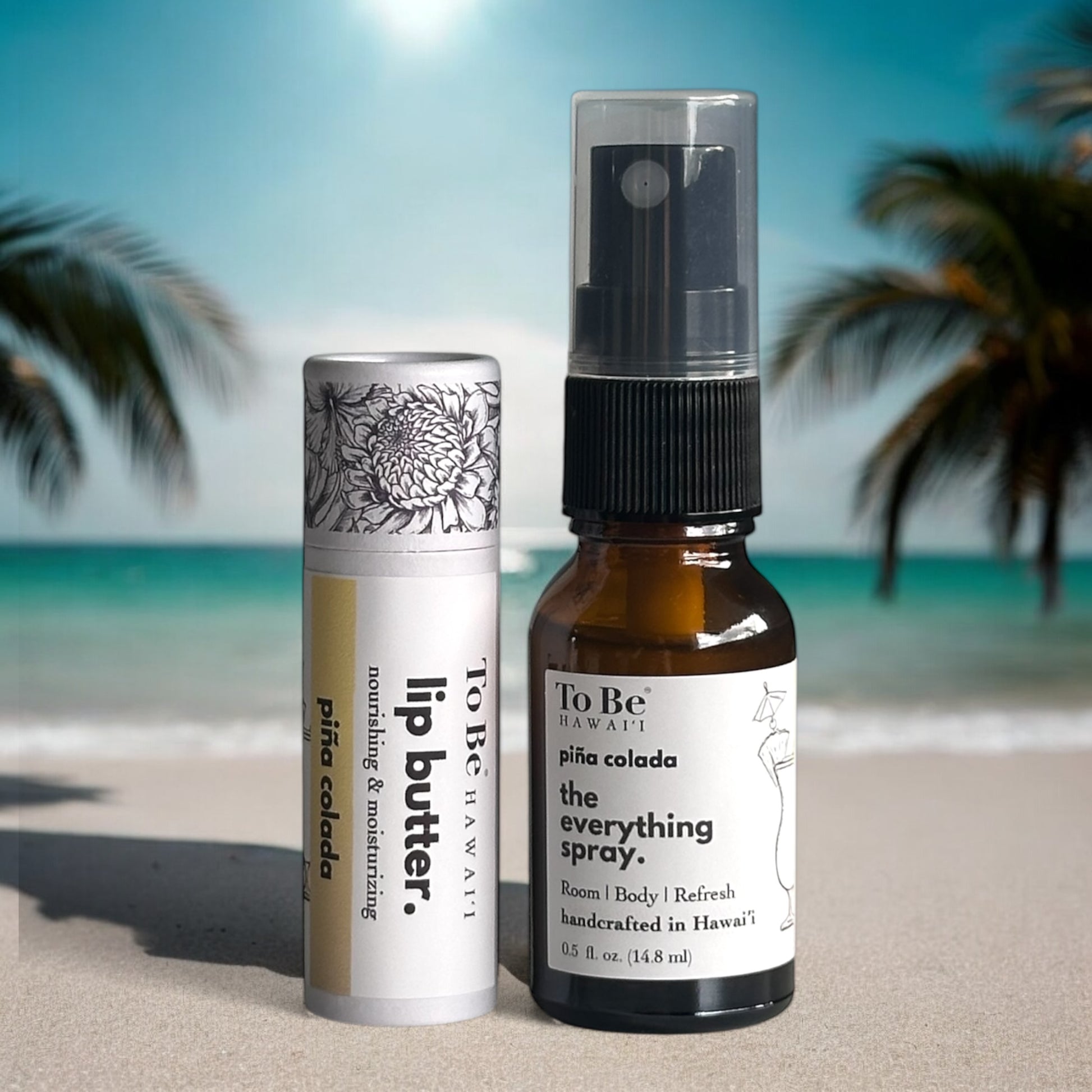 Two products, a lip butter and an everything spray bottle, on a beach with palm trees in the background.