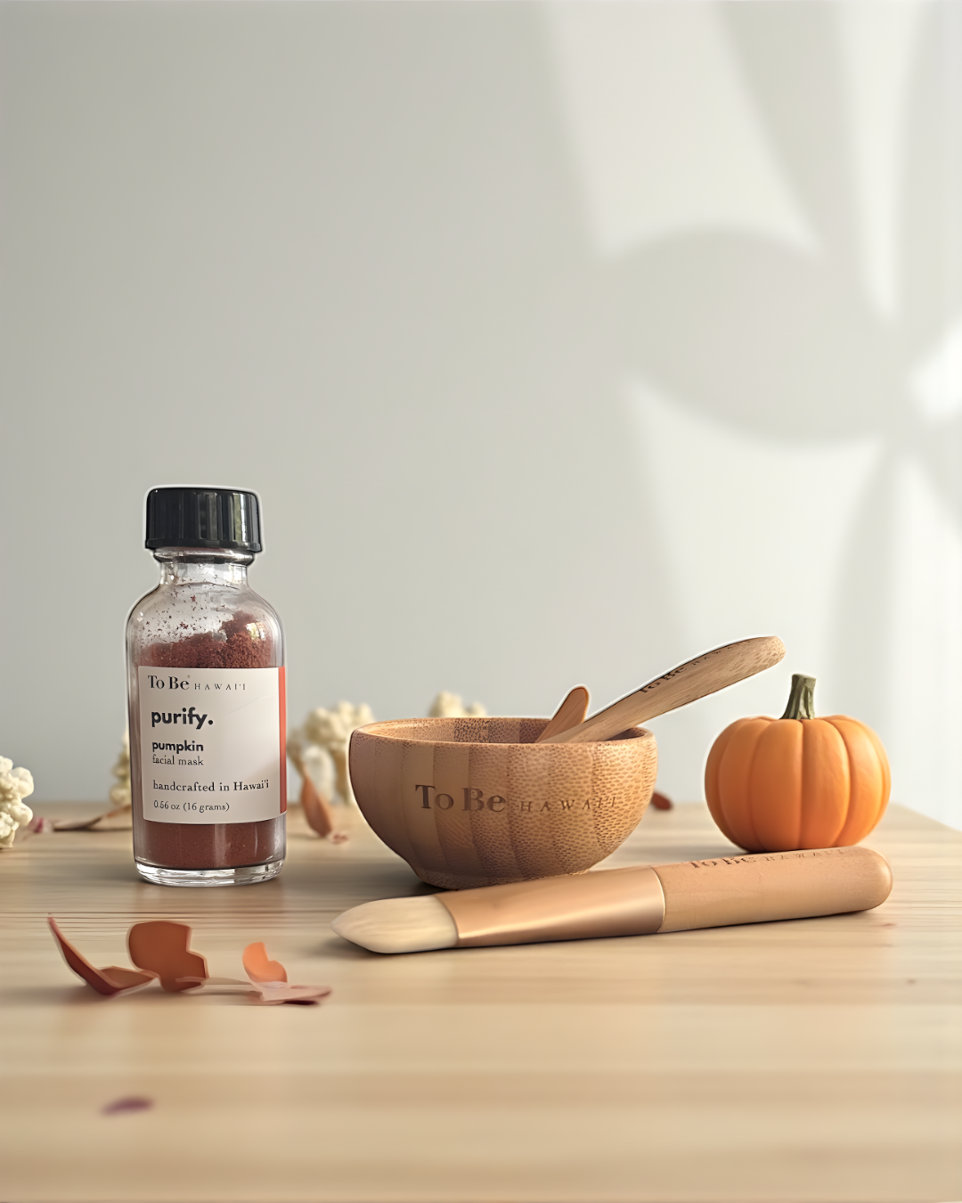 Bottle labeled 'purify pumpkin' on a wooden surface with a wooden bowl and pumpkin.